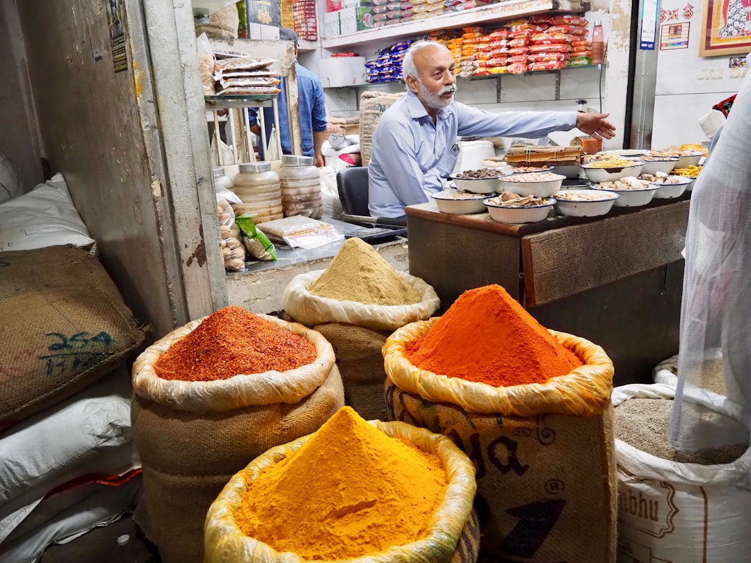 Vendor selling colorful spices in a market